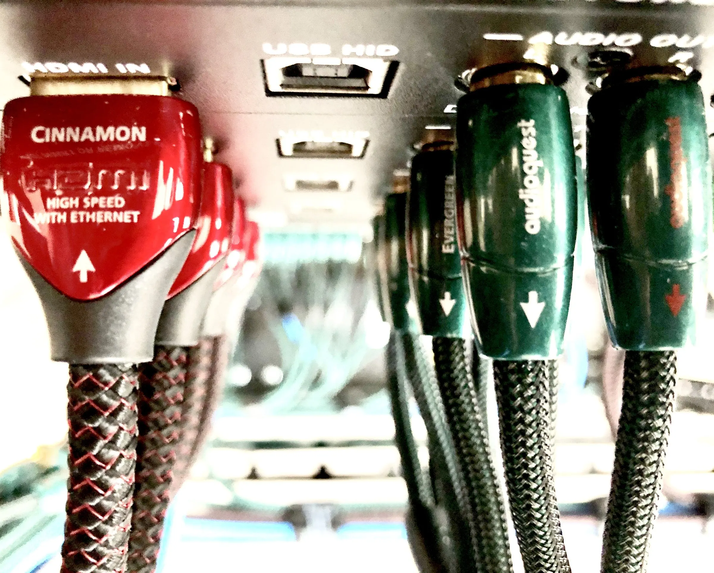 Close-up of braided premium HDMI and audio cables connected to equipment