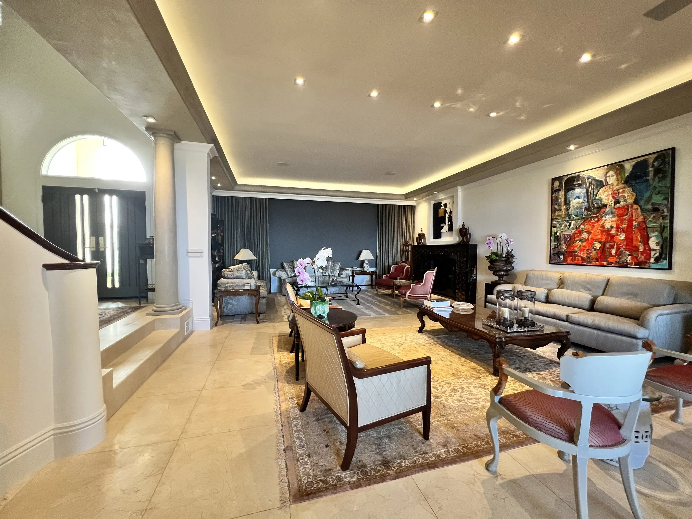 Main living floor with warm cove lighting along the ceiling