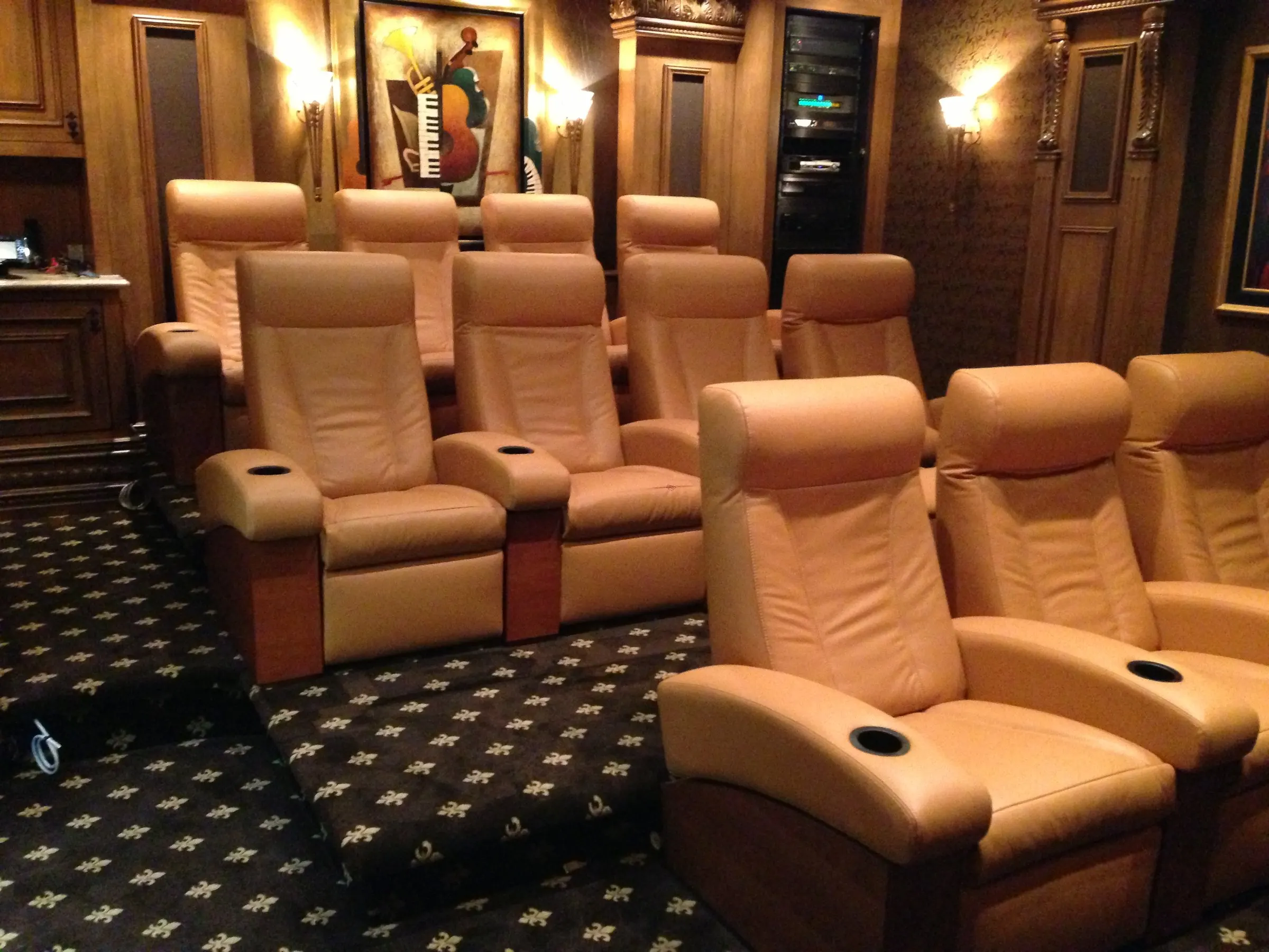 Traditional home theater with two rows of leather recliners and wood-paneled walls