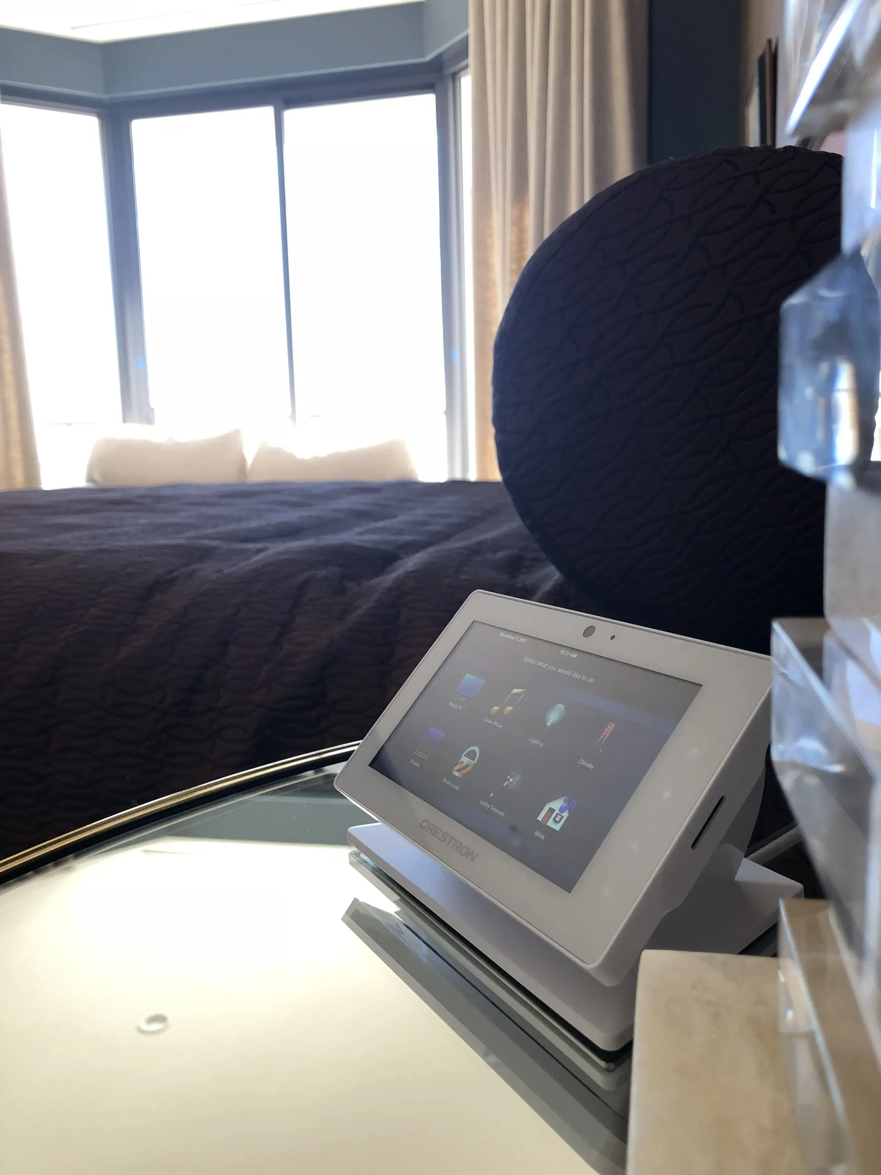 Tabletop control touch panel on a nightstand in a primary bedroom